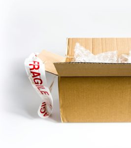 picture of a a open cardboard box showcasing How Professional Removal Companies Protect Fragile Items